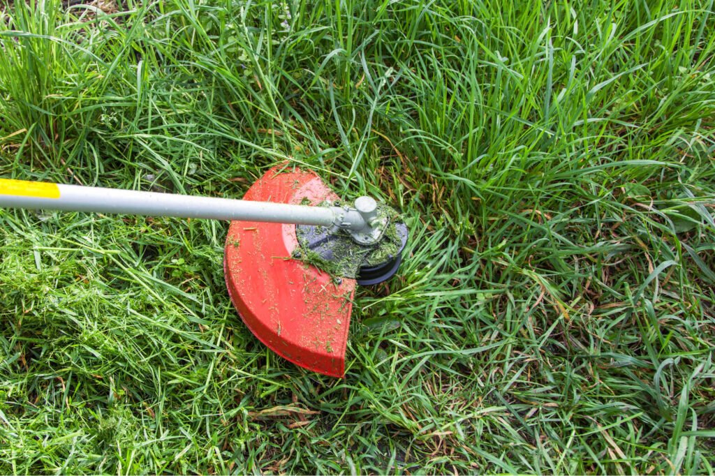 Grass trimmer in action, cutting grass. Wiltshire Tree Care. Hedge Trimming, Tree Surgeons, Cutting Hedges, Stump Removed, Tree Stump Grinding, Bush Shrub Trimming, Tree and Stump Removal, Stump Grinding Service. Devizes, Wiltshire.